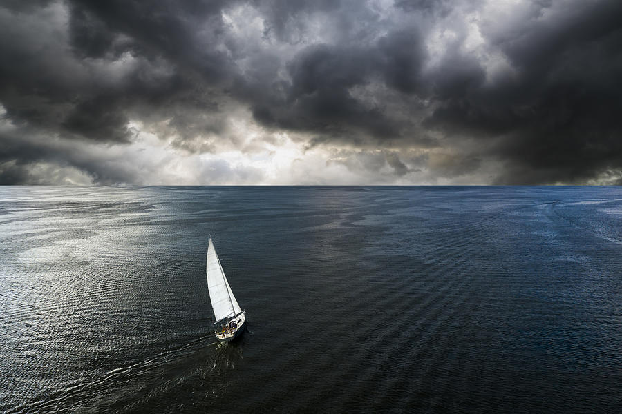 Aerial view of a yacht in a storm with a dramatic sky Photograph by Anton Petrus