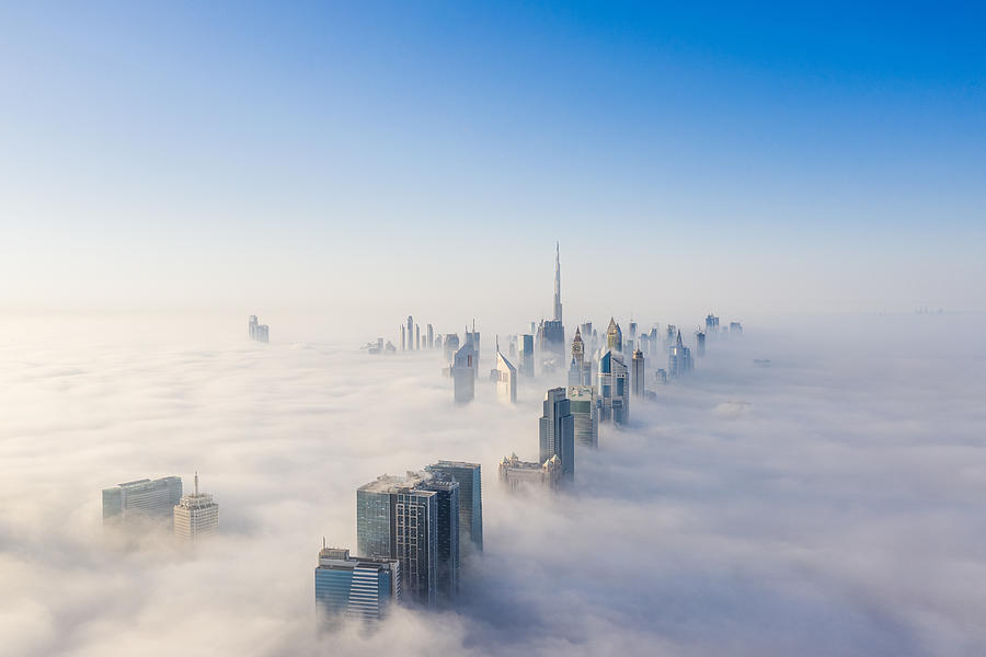 Aerial view of Dubai frame and skyline covered in dense fog during winter season Photograph by Captured Blinks Photography