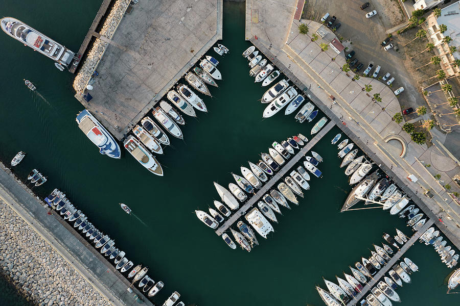 Aerial view of fishing boats and tourist yachts moored at the marina.  Photograph by Michalakis Ppalis