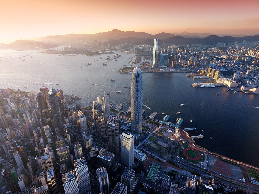 Aerial view of Hong Kong city, Victoria harbour in sunset Photograph by Zorazhuang