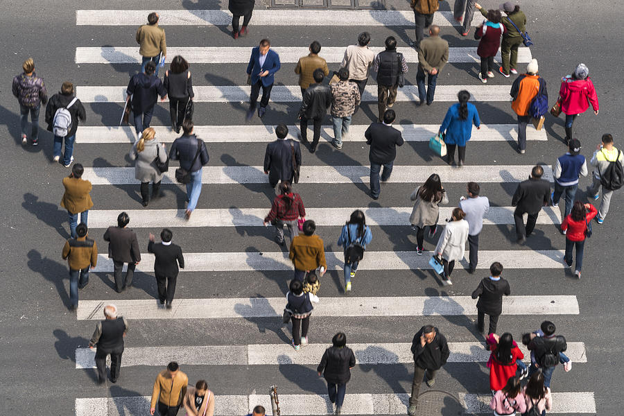 Aerial view of people on busy pedestrian crossing, Shanghai, China Photograph by Peter Adams
