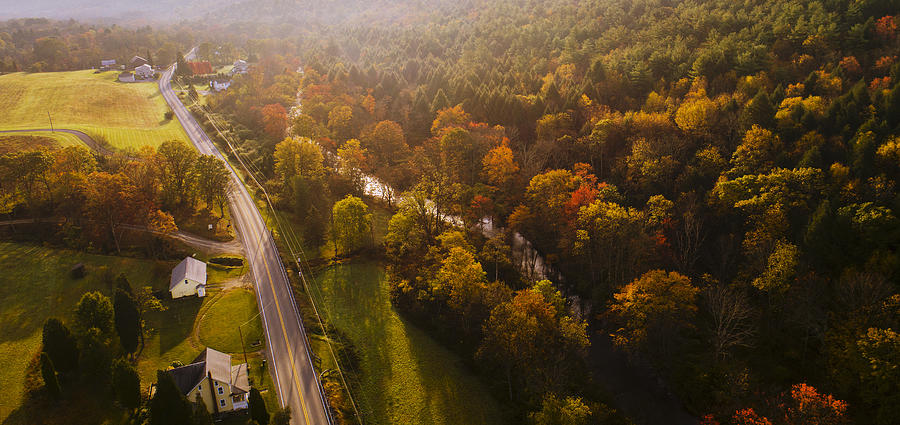 Aerial view of the country road in the forest in the mountain in the autumn foggy morning. Photograph by Alex Potemkin