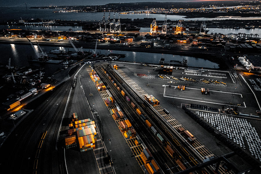 Aerial view of the New Jersey Shipyard with numerous cranes, gantries and shipping containers, captured at golden hour Photograph by Extreme Media