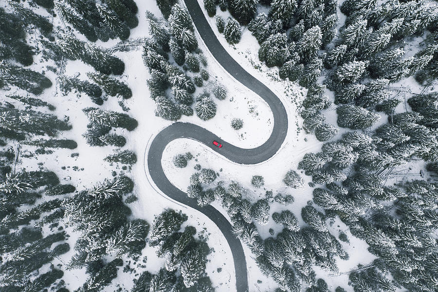 Aerial view of winding road in winter forest Photograph by © Marco Bottigelli