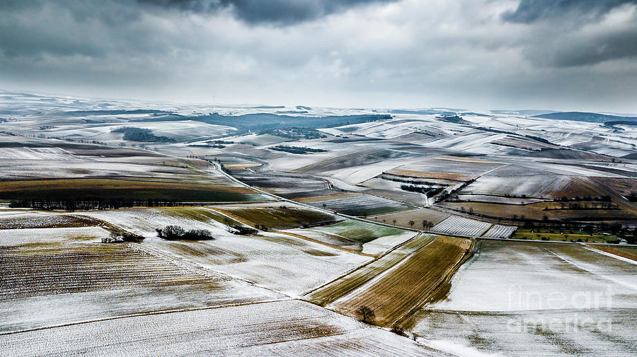 Aerial View Of Winter Landscape With Remote Settlements And Snow Covered Fields In Austria Photograph by Andreas Berthold