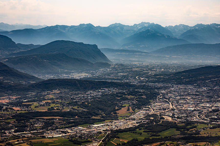 Aerial view on the French city of Chambery and its surroundings at dusk with mist between the Alps mountains Photograph by Gregory_DUBUS