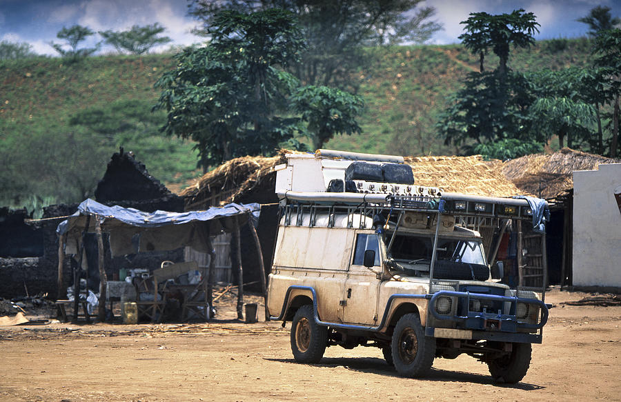 Africa, Southern Africa, Mozambique, View Of Safari Vehicle On Dirt Track In African Village (Year 2000) Photograph by Kypros