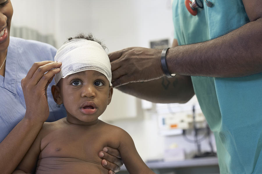 African American baby having head bandaged at hospital Photograph by ER Productions Limited