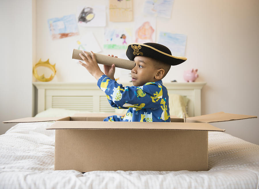 African American boy playing in cardboard box Photograph by Blend Images - JGI/Jamie Grill