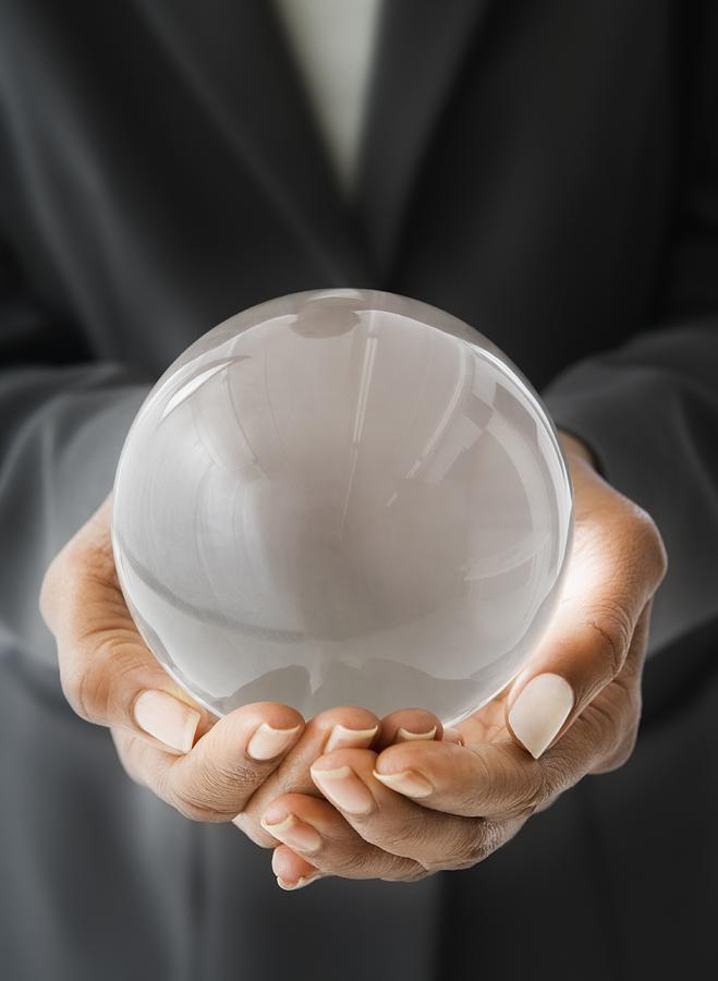 African American businesswoman holding crystal ball Photograph by Jose Luis Pelaez Inc