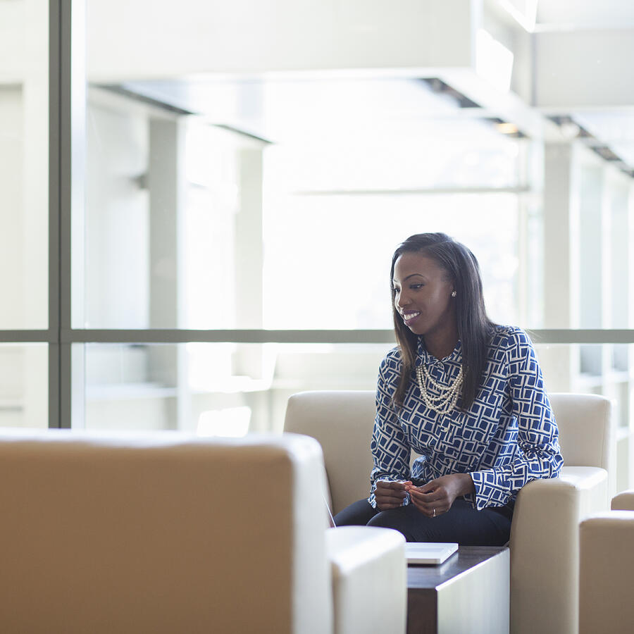 African American businesswoman sitting in office lobby Photograph by Jetta Productions Inc