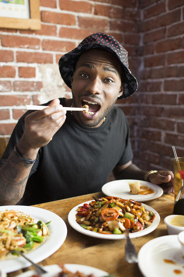African American man eating at restaurant Photograph by Hello Lovely