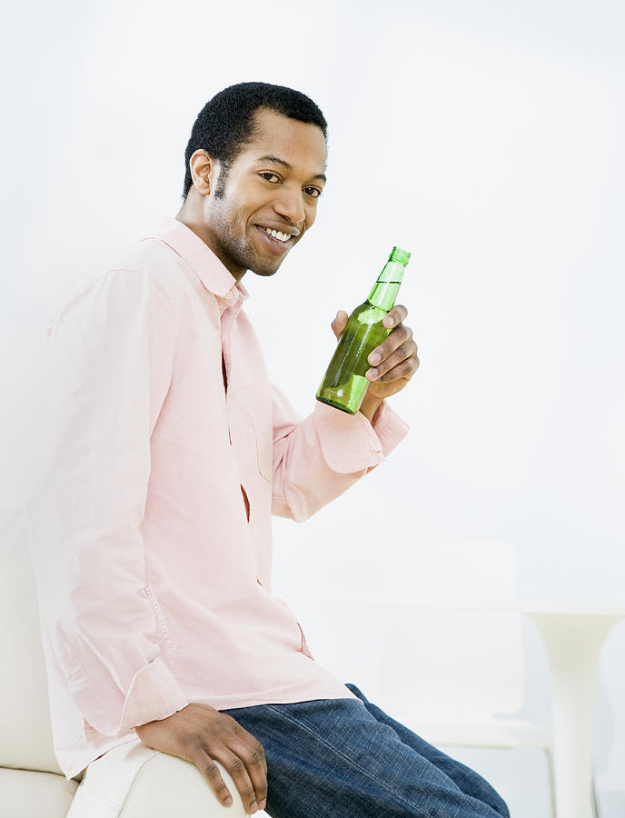 African American man holding bottle of beer Photograph by Andersen Ross Photography Inc