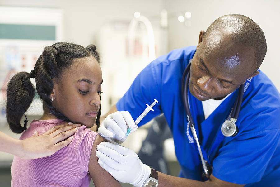 African American nurse giving patient injection Photograph by ER Productions Limited