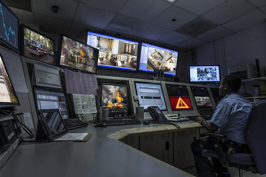 African American security officer working in control room Photograph by Jon Feingersh Photography Inc