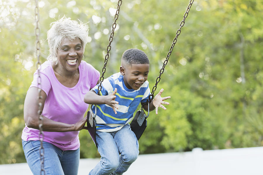 African-American senior woman, grandson on swing Photograph by Kali9