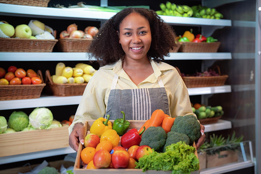 African american woman grocery working in supermarket with fruit ...