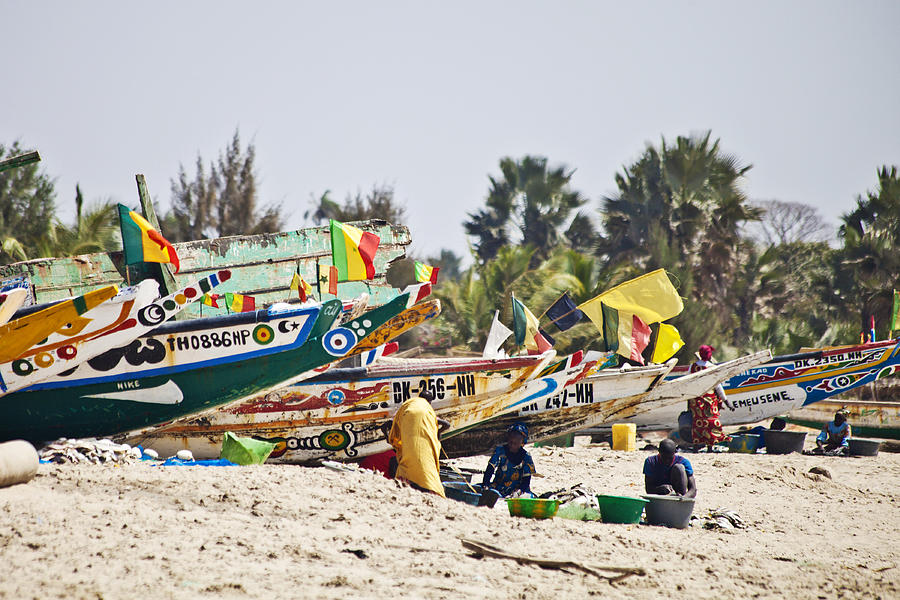 African beach scene with fishing boats. Photograph by Peeterv