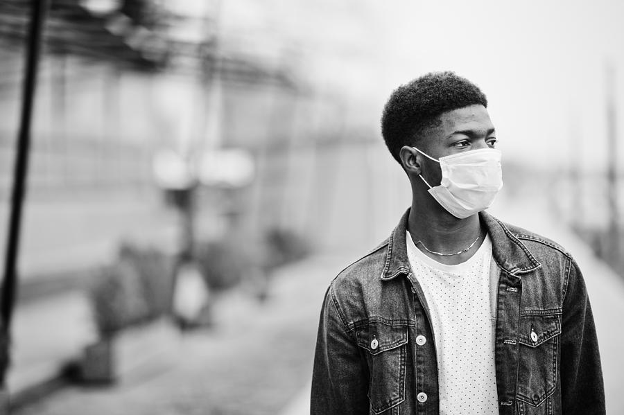 African man at park wearing medical masks protect from infections and diseases coronavirus virus quarantine. Photograph by ASphotowed