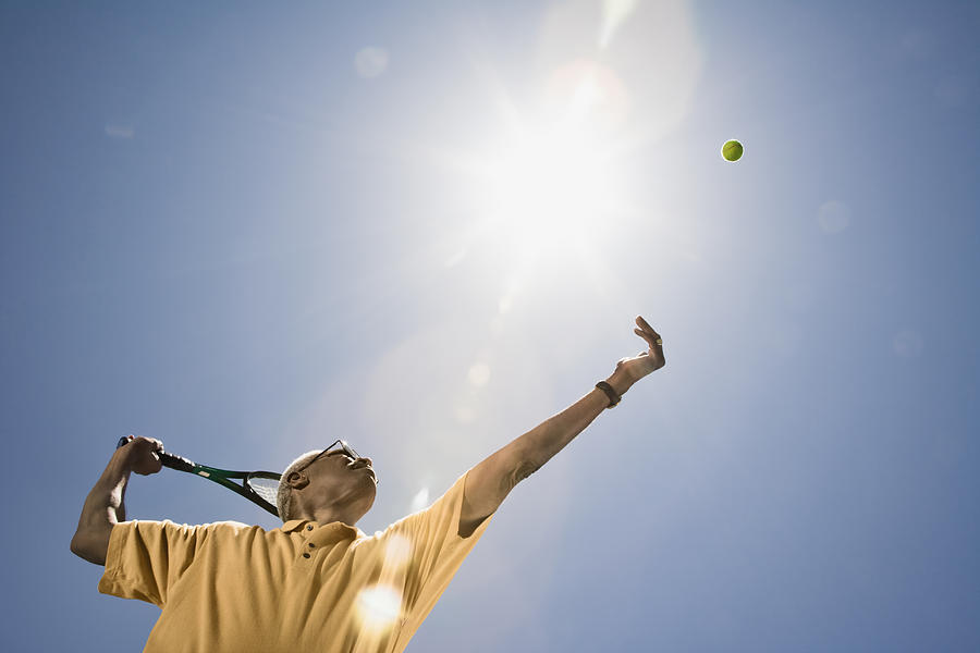 African man playing tennis Photograph by ER Productions Limited
