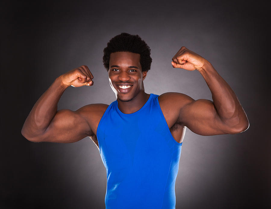 African Man Showing Muscle Photograph by AndreyPopov