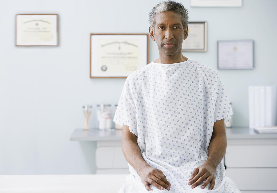 African man wearing hospital gown Photograph by Jose Luis Pelaez Inc