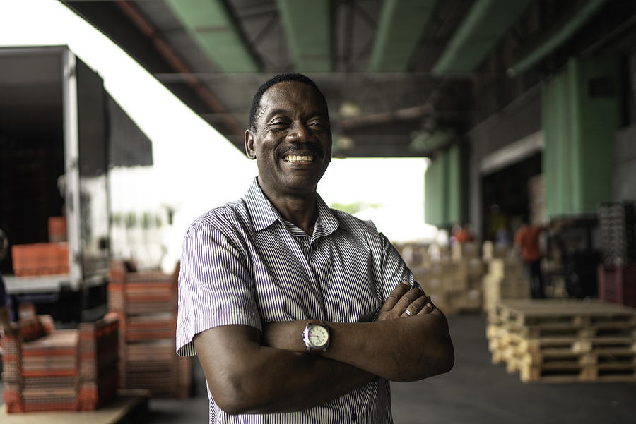 African mature man owner portrait at warehouse Photograph by FG Trade