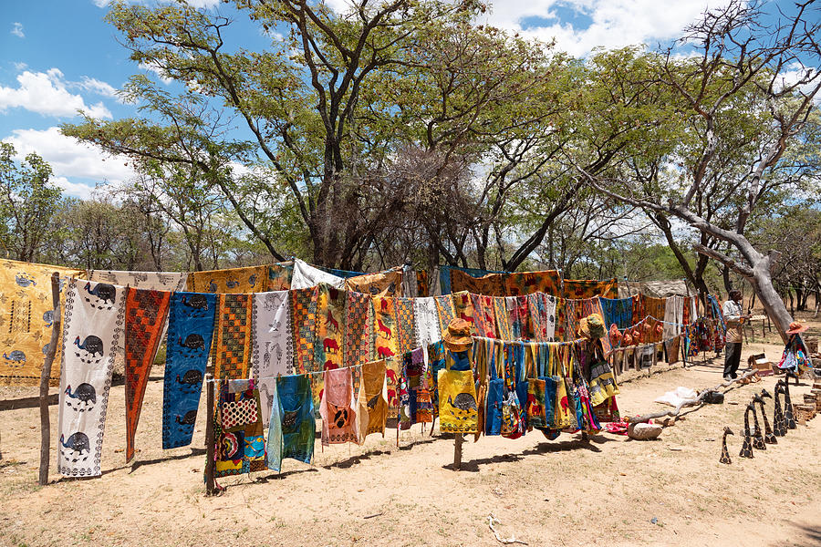 African traditional textile and souvenirs for sale on a street market stall , Matopos National Park,Zimbabwe Photograph by Brytta