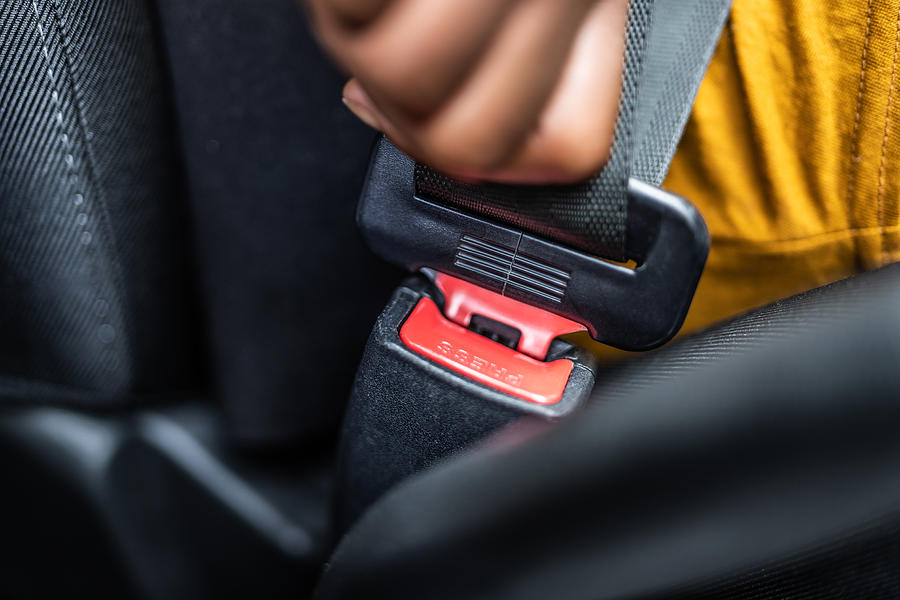 African Woman Buckling Up Seatbelt Photograph by AndreyPopov