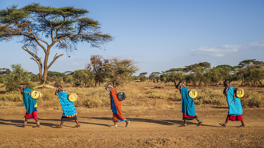 African women from Maasai tribe carrying water, Kenya, East Africa Photograph by Hadynyah