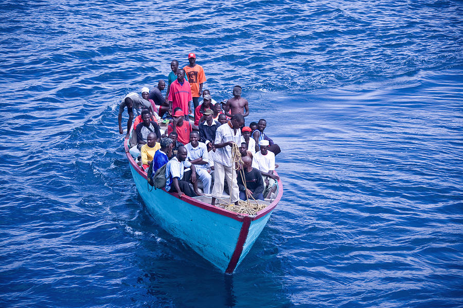 Africans in an overloaded boat Photograph by SeppFriedhuber