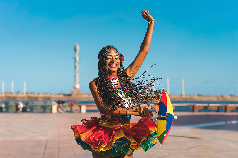 Afro dancer holding a Frevo umbrella in Marco Zero Photograph by MesquitaFMS
