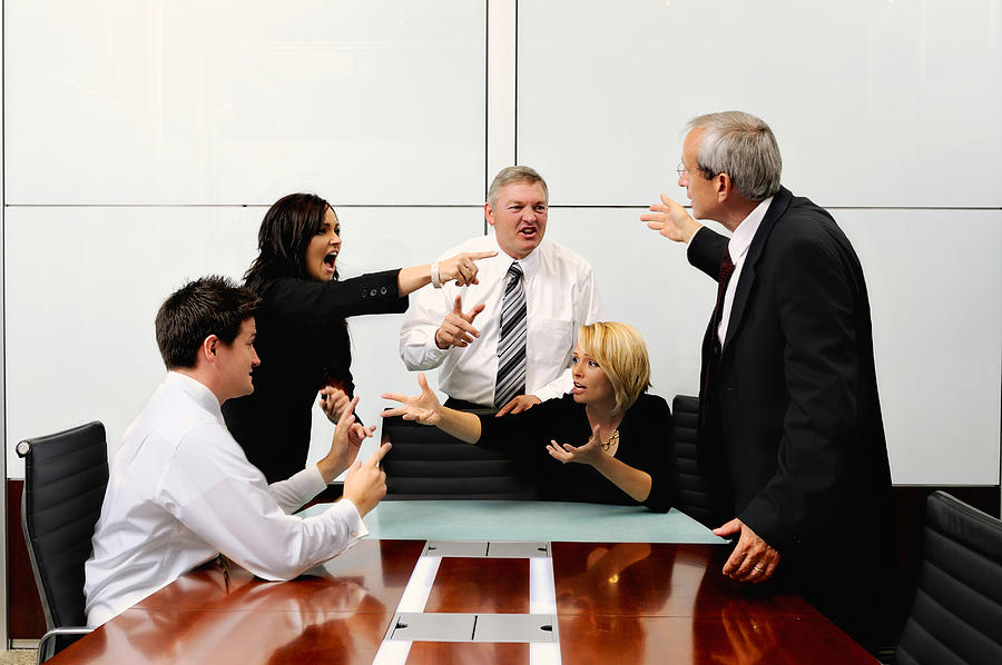 Agitated business people at a meeting pointing at each other Photograph by ImagesbyTrista