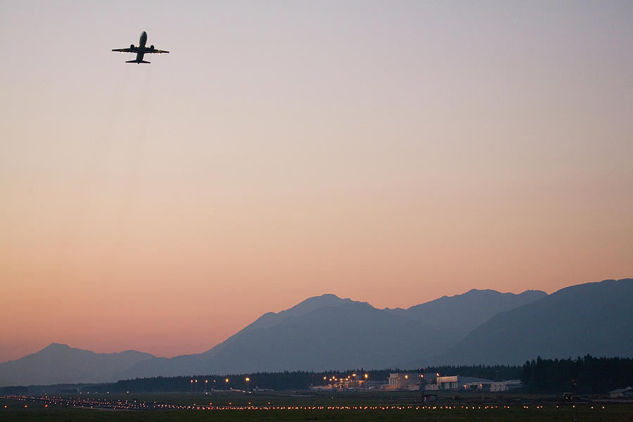 Aircraft taking off at dusk from Ljubljanas Joze Pucnik Airport  Photograph by Ian Middleton