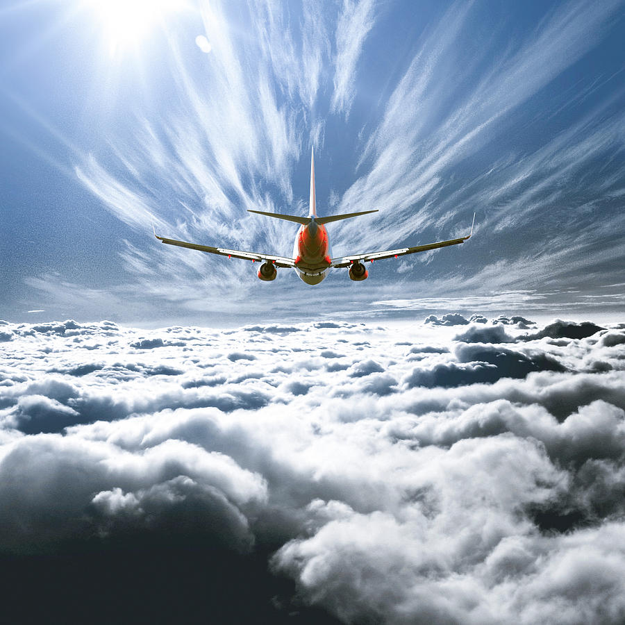 Airplane flying above the clouds Photograph by Mattscutt
