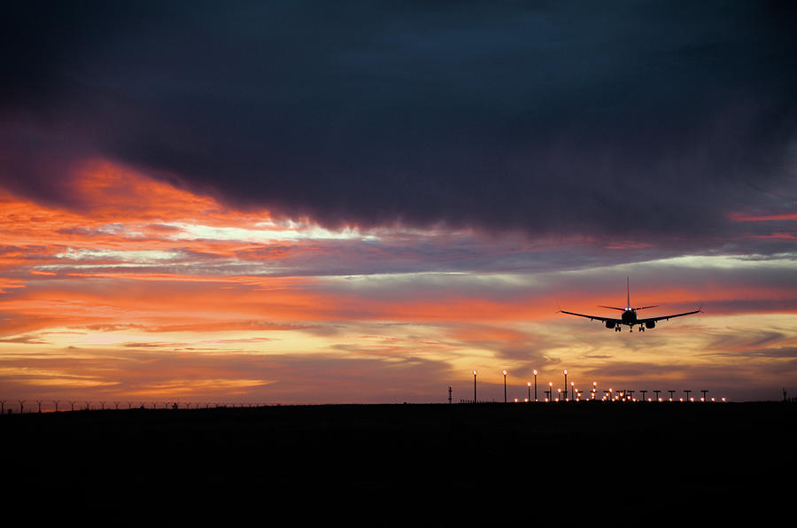 Sunset Photograph - Airplane Landing at Dusk by Angelo DeVal