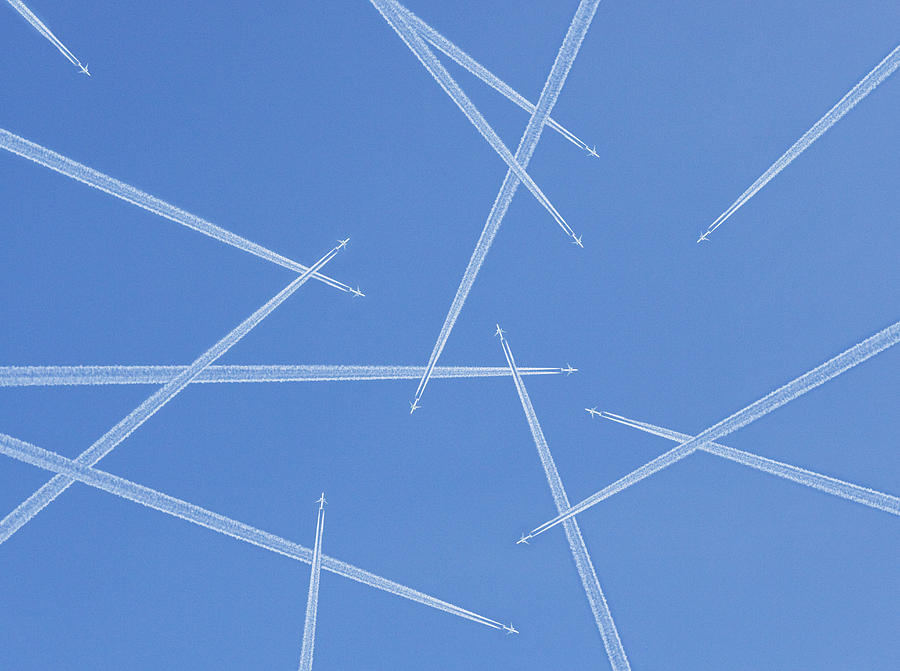 Airplanes against blue sky, directly below Photograph by Kindler, Andreas