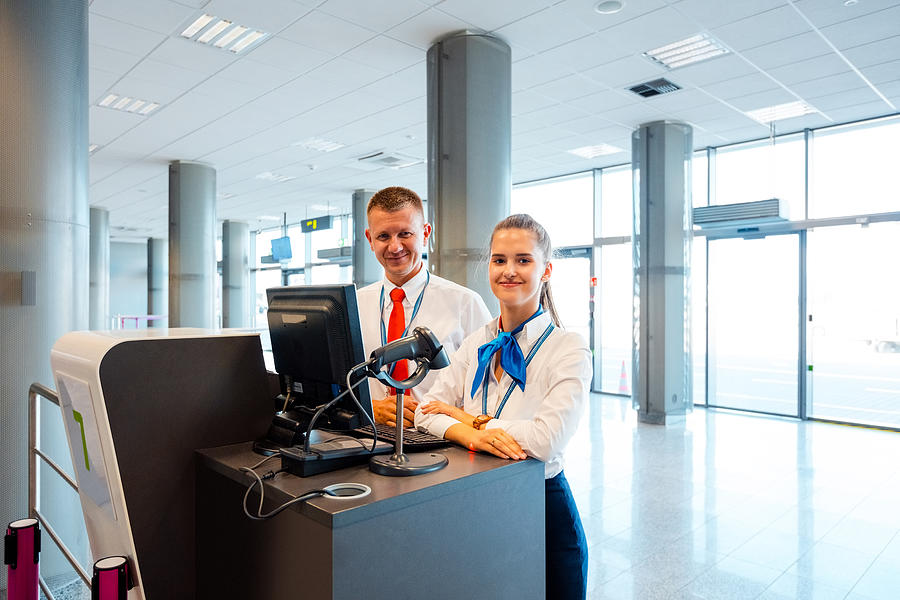Airport service team at the boarding desk Photograph by Izusek