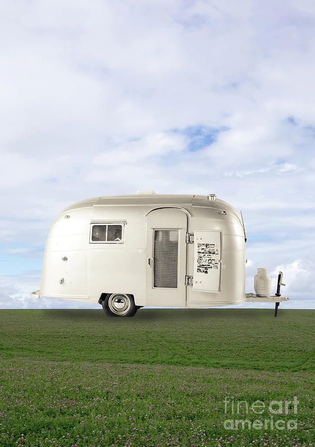 Airstream Travel Trailer in field Photograph by Edward Fielding
