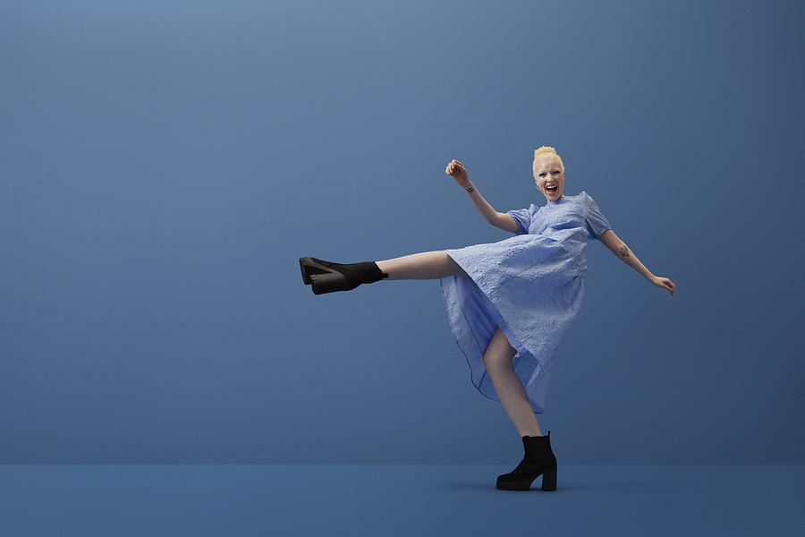 Albino woman shouting while kicking leg Photograph by Klaus Vedfelt