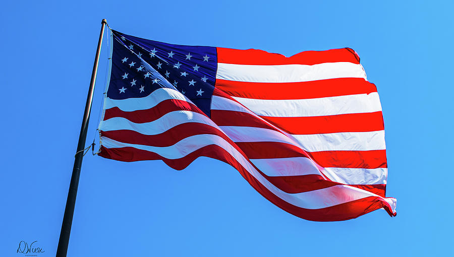 American Flag Against A Brilliant Blue Sky Photograph By Denise Wiese 