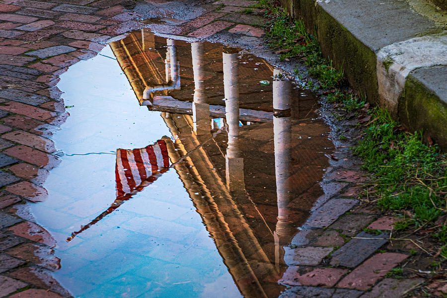 American Flag in a Puddle Reflection Photograph by Stuart Litoff