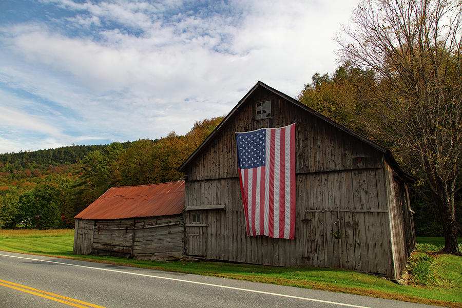 American flag on rustic barn in rural Vermont Photograph by Eldon McGraw