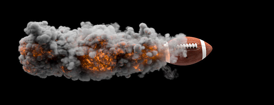 American football ball flying wrapped in flames and smoke Photograph by Gualtiero Boffi