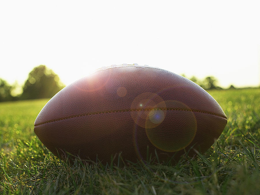 American football on grass, side view Photograph by Steven Puetzer