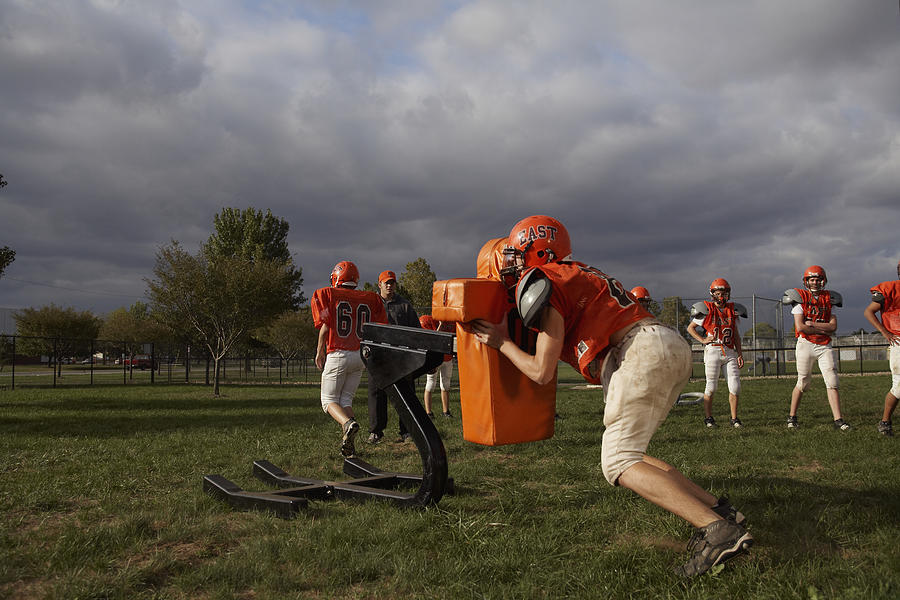 American football players including teenagers (15-17) training in field Photograph by Darrin Klimek