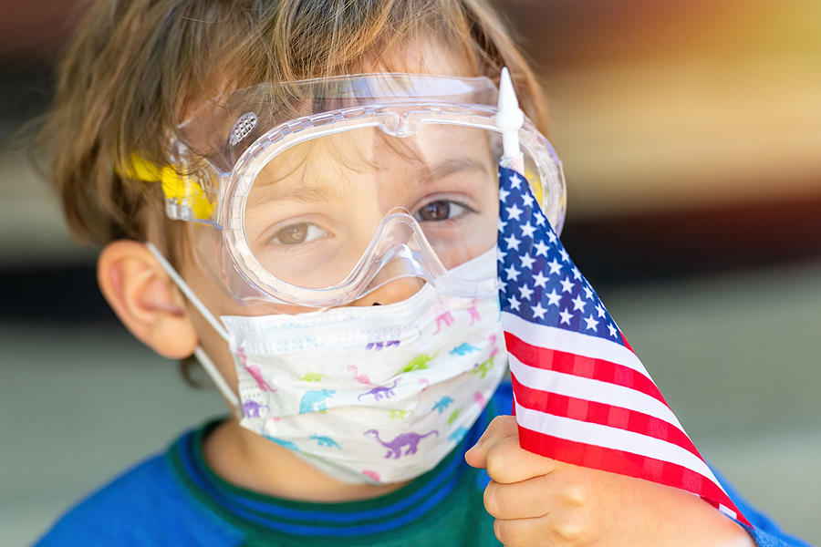 American little caucasian boy posing with a protective mask, protective glasses holding a US flag Photograph by Juanmonino
