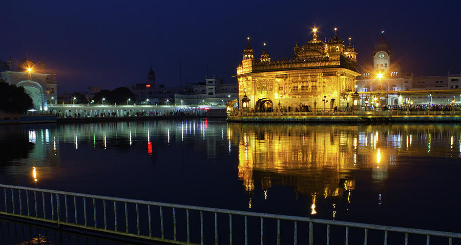 Amritsar, India  Wide angle long shot of illuminated Harmindar Sahib, aka Golden Temple. Religious place of Sikhism. Sikh gurdwara in the holy pond at night with reflection Photograph by Arpan Bhatia