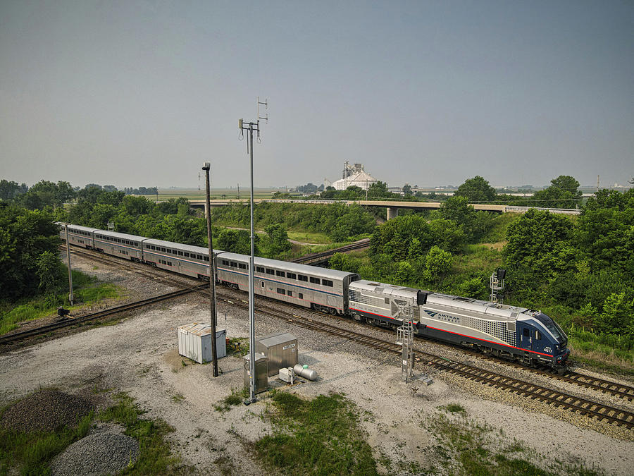 AMTRAK 390 heads north across the diamond at Tuscola IL Photograph by Jim Pearson