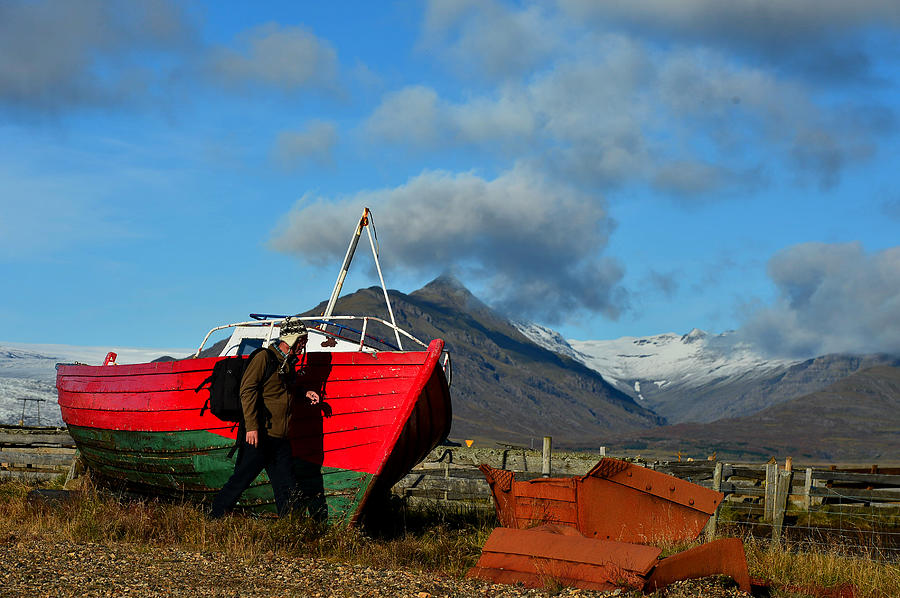 An abandoned boat  on the shores with  mountain Photograph by Redtea